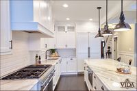 built-in dishwasher, wooden finishes, built in range hood, built in oven hood, hanging lights